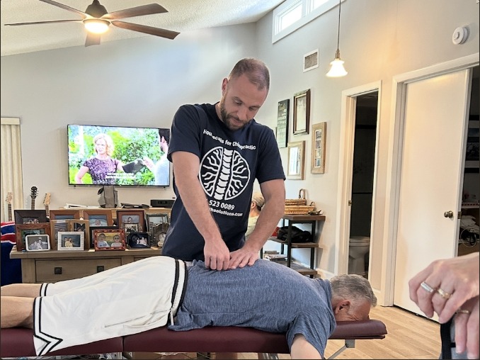 Chiropractor providing care to a patient in a comfortable home setting