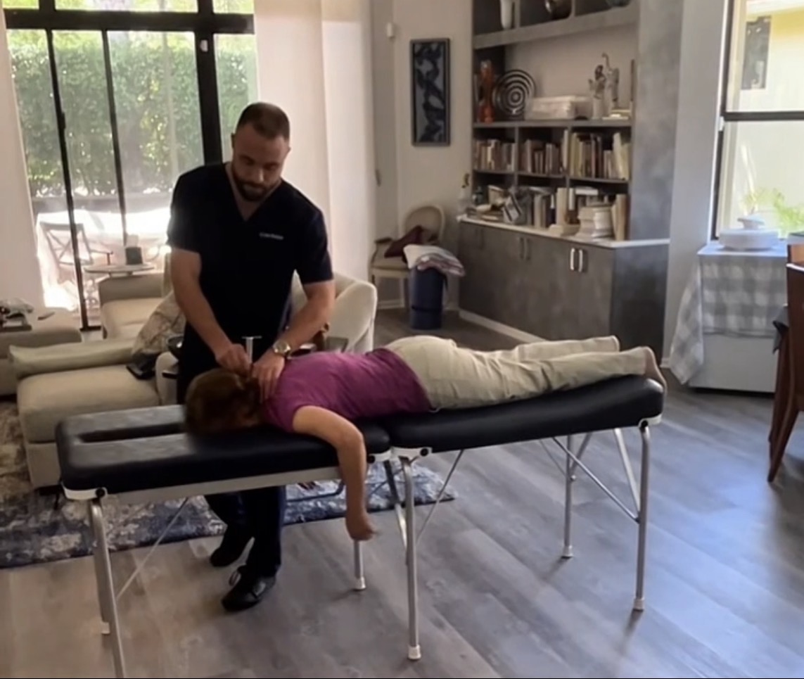 Dr. Yale Gordon delivering a house call chiropractic adjustment in Palm Beach County